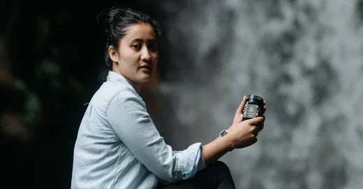 a woman with mad honey jar on her hand