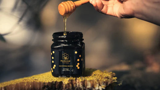 a person pouring mad honey in the jar