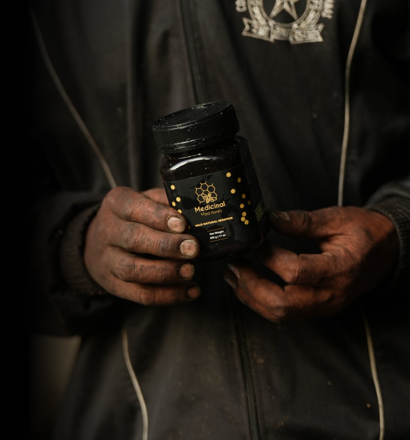 Person carrying mad honey jar