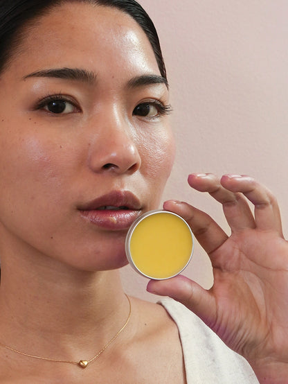 A beautiful lady showing mad honey lip balm