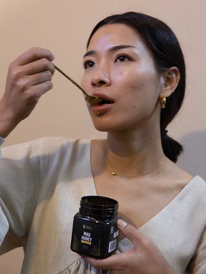 A girl tasting mad honey from Nepal 