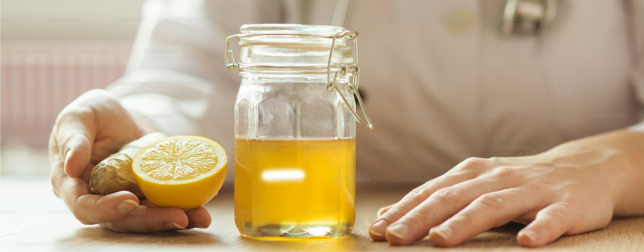 A jar of honey, a slice of lemon and ginger for cough relief and congestion