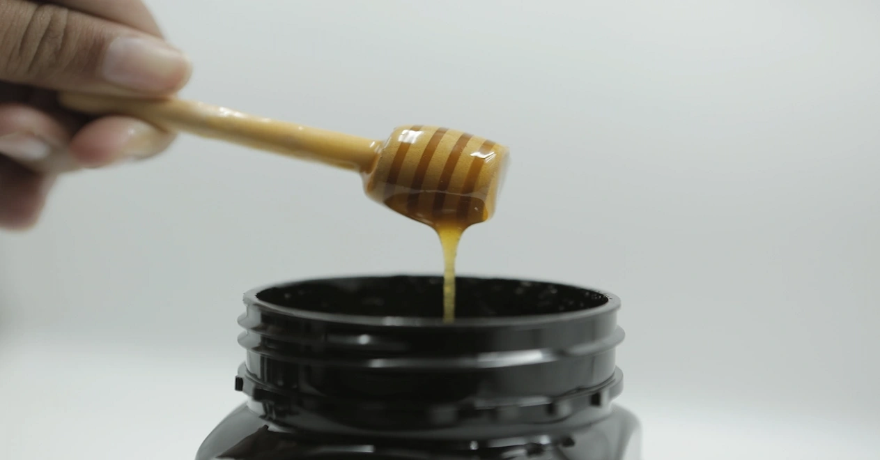 mad honey dripping into the jar
